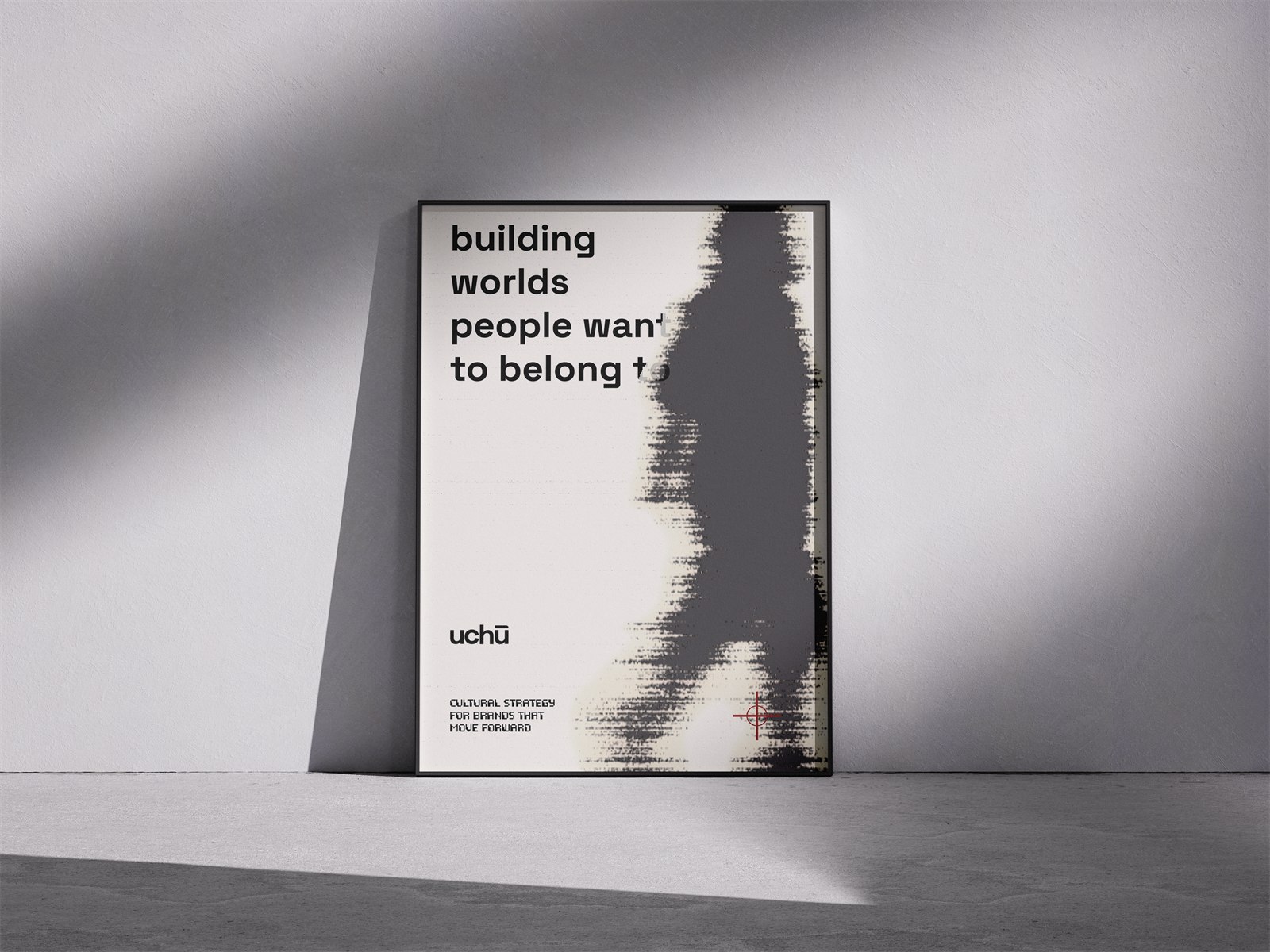 Een ingelijste poster van uchu tegen een witte wand, met de zin building worlds people want to belong to